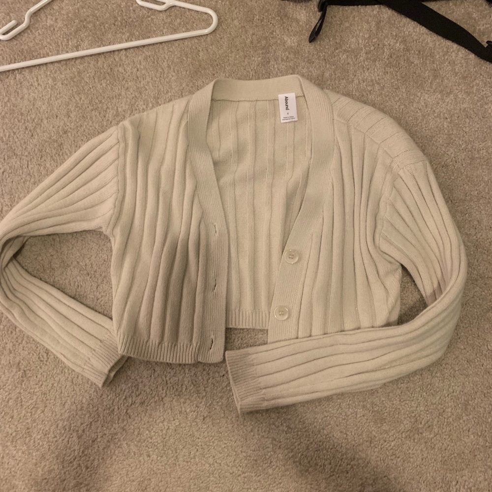 Beige cropped cardigan sweater rubbed with buttons